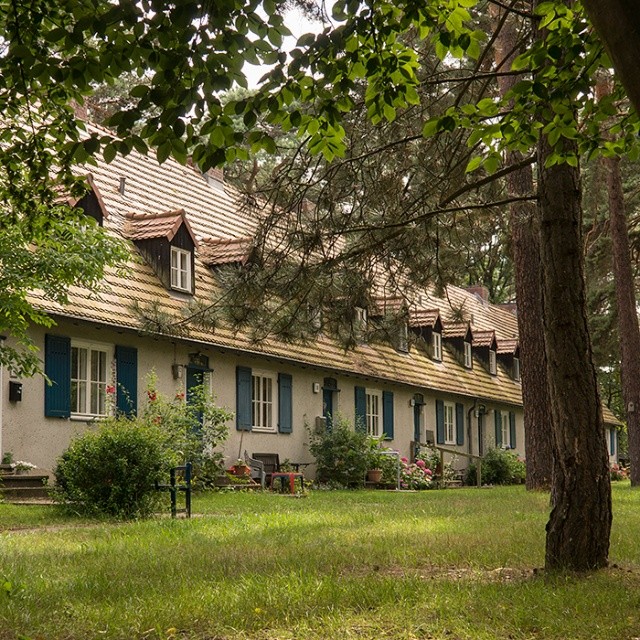 designed by  and constructed between 1937 and 1940.   in a  version: the individual must submit to the collective, command economic allocation of scarce resources co-exists with private proporty to a certain degree but property can easily be confiscated by the State. The settlement was made for SS-personnel and their families.
